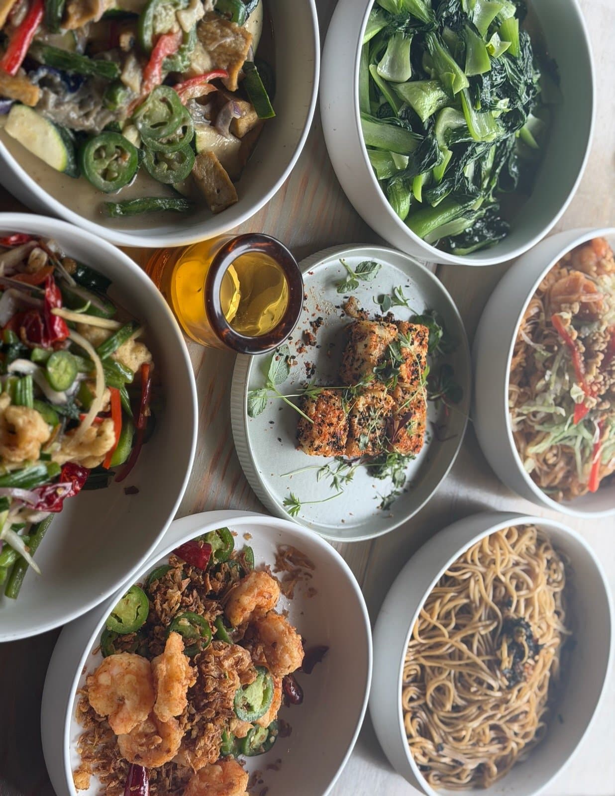 Shared Chinese dishes on a wooden table
